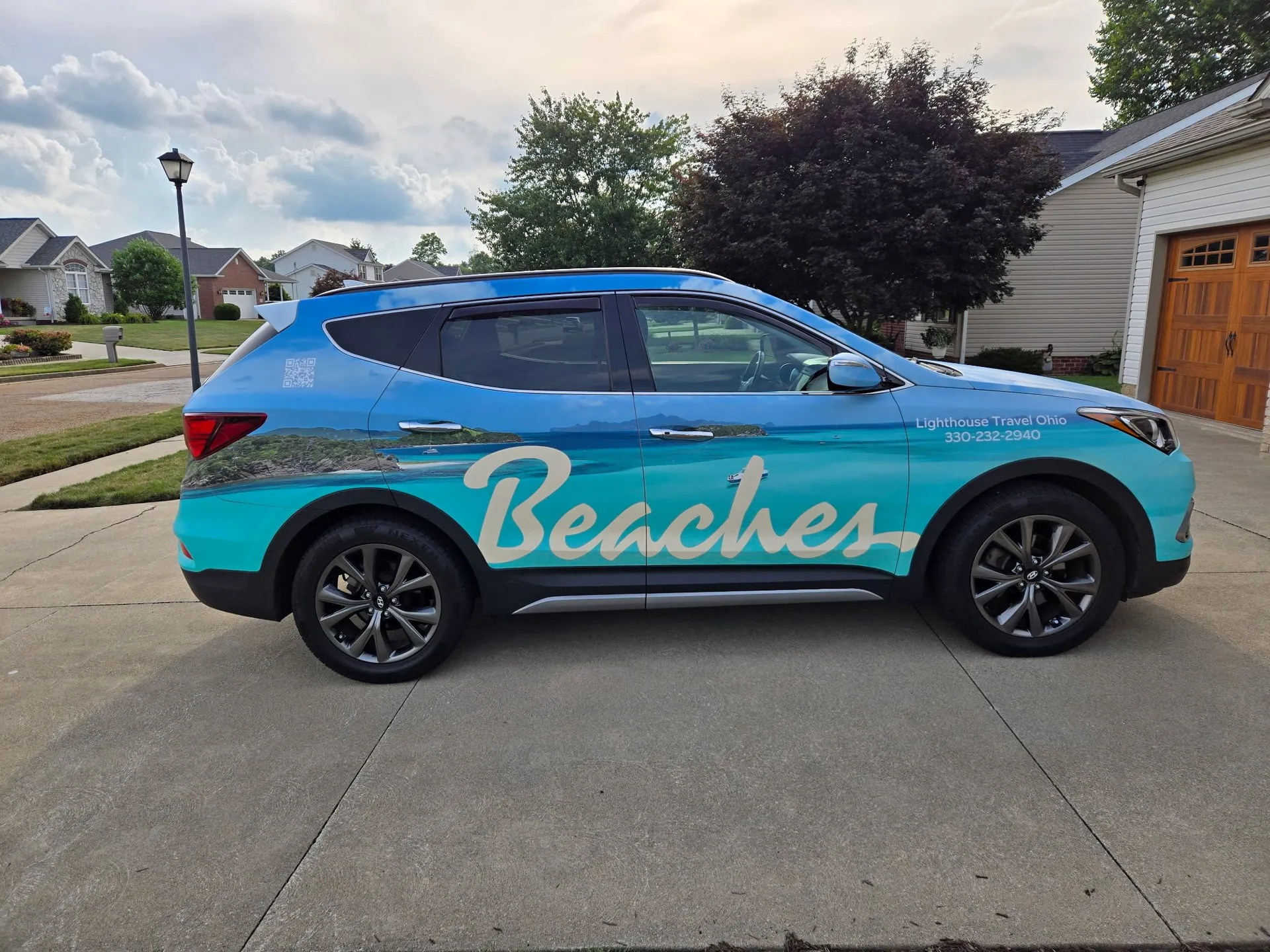 Hyundai Santa Fe with a full printed beach-scene wrap for Lighthouse Travel Ohio